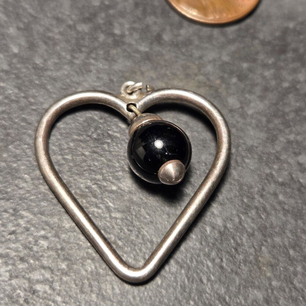 Sterling silver pendant with black dangle bead